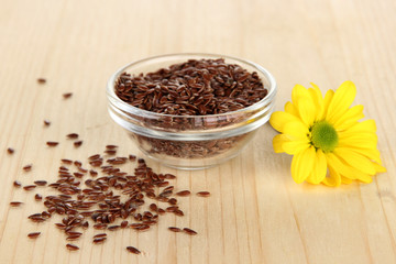 Useful flax seeds on wooden table close-up