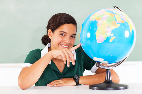 teenage school girl pointing the globe