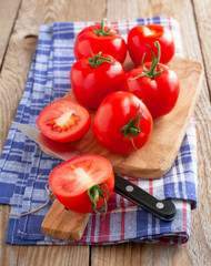Fresh, ripe tomatoes on the chopping board