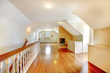 Large long attic room with fireplace.