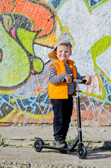 Proud little boy with his scooter