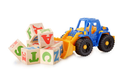 Wooden alphabet blocks with a toy tractor