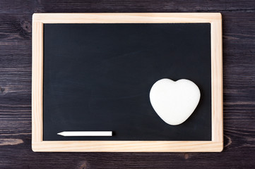 Slate chalk board on wooden background