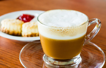 Coffee and bread on wooden table