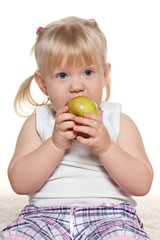 Portrait of a little girl eating an apple