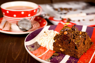 Fototapeta na wymiar Piece of chocolate cake brownie and a cup of tea