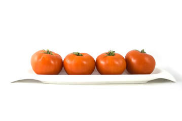 Tomatoes in a plate isolated on white