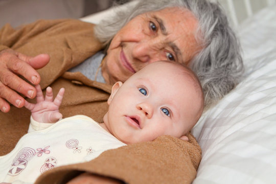 Great Grandma Laying Down With Baby