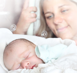 Newborn baby boy sleeping in a incubator.