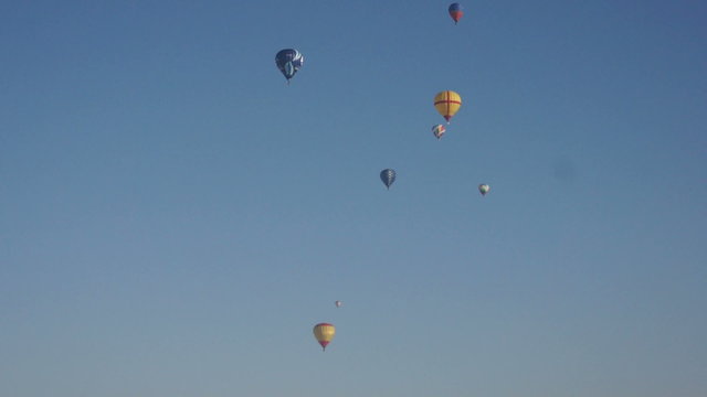 Image of many colorful hot air balloons in sky