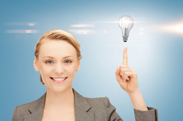 woman pointing her finger at light bulb