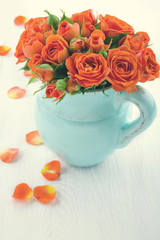 Roses on white wooden background