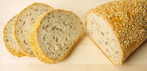 Pieces of sesame seed bread on a pastry board