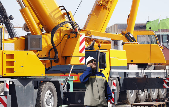 Giant Mobile Crane With Driver Talking In Phone