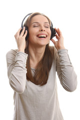 Naklejka premium Young woman listening music with headphones, on white