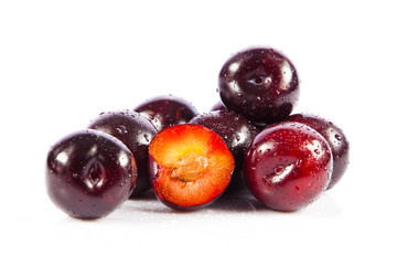 Red plum fruit isolated on white background.  Fresh ripe washed