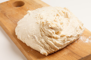 Dough on wooden board