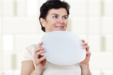 Woman with blank plate in his hand