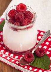 White yogurt with strawberry and spoon