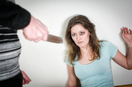 Man with knife coming to his wife. Home violence concept