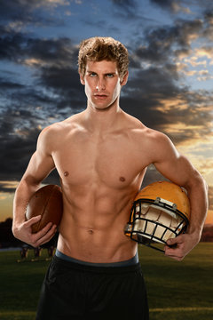 Young Man Holding Football and Helmet