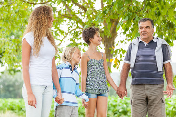 Naklejka premium Happy Three Generations Family Outdoor
