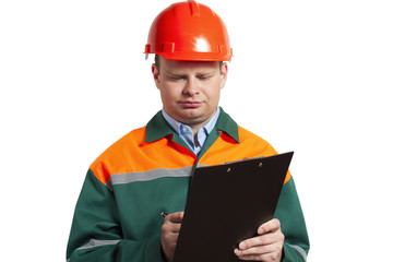 Foreman in uniform writes in a paper notebook