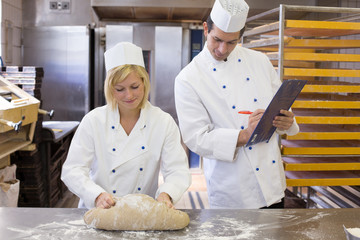 Instructor instructing an apprentice in bakery
