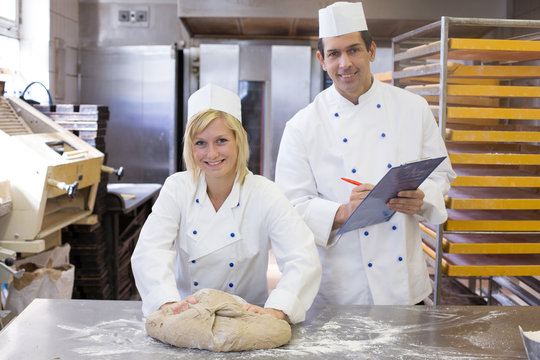 Instructor instructing an apprentice in bakery