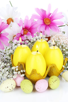 Easter candles with flowers close up