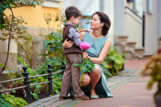 Little Boy Giving Flower To His Mom