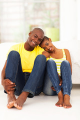 young african couple sitting on the bedroom floor