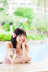 a young asian woman relaxing in the resort hotel