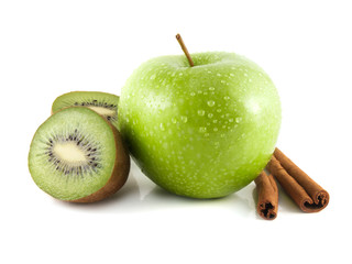 Isolated wet green apple with kiwi, cinnamon pods