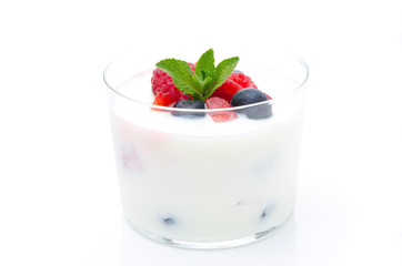 yogurt with different fresh berries, mint in a glass beaker