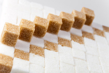 Cubes of not refined reed sugar and white sugar
