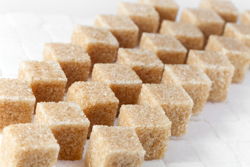 Cubes of not refined reed sugar and white sugar