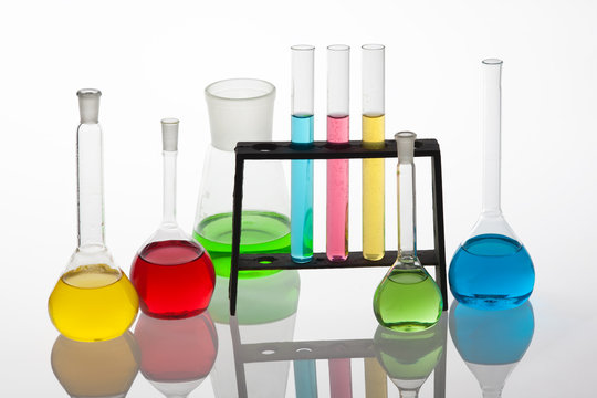 Chemisty set with laboratory glassware filled with various colou