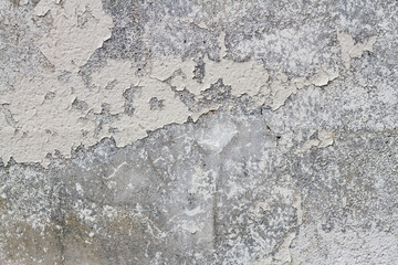 Grey wall texture with cracked and peeling paint
