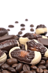Chocolate candy with coffee beans on a white background .