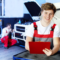 Apprentices for car mechanic is satisfied with his job