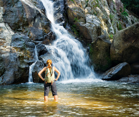 Female hiker looking at waterfall