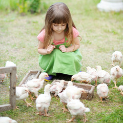 portrait of a little girl and chickens