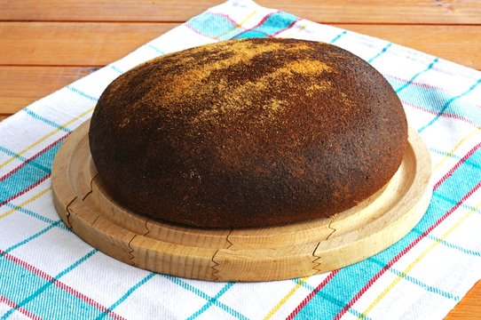 Wholewheat loaf on wooden board © Arena Photo UK