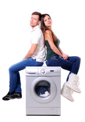 beautiful young couple with a washing machine
