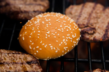 Beef cutlet on grill with bun