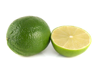 Isolated green lime with sliced half on a white