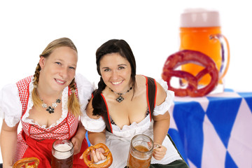 two woman in dirndl with beer mug and pretzel