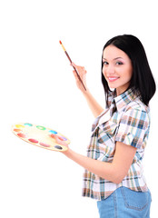 Fototapeta premium Beautiful young woman painter with brushes and palette at work,