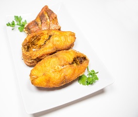 Portions of deep fried red snapper fish.